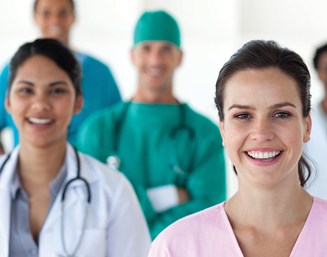 Smiling healthcare team standing in clinic setting