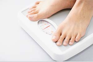 Feet standing on weighing scale